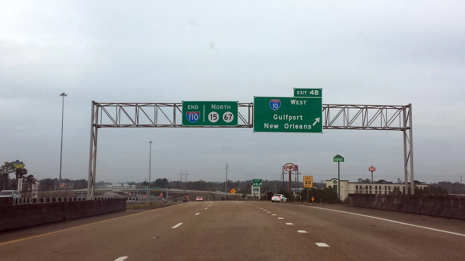 The highway sign gantry at the northern terminus of I-110 in D’Iberville, Mississippi, marking the interchange with I-10