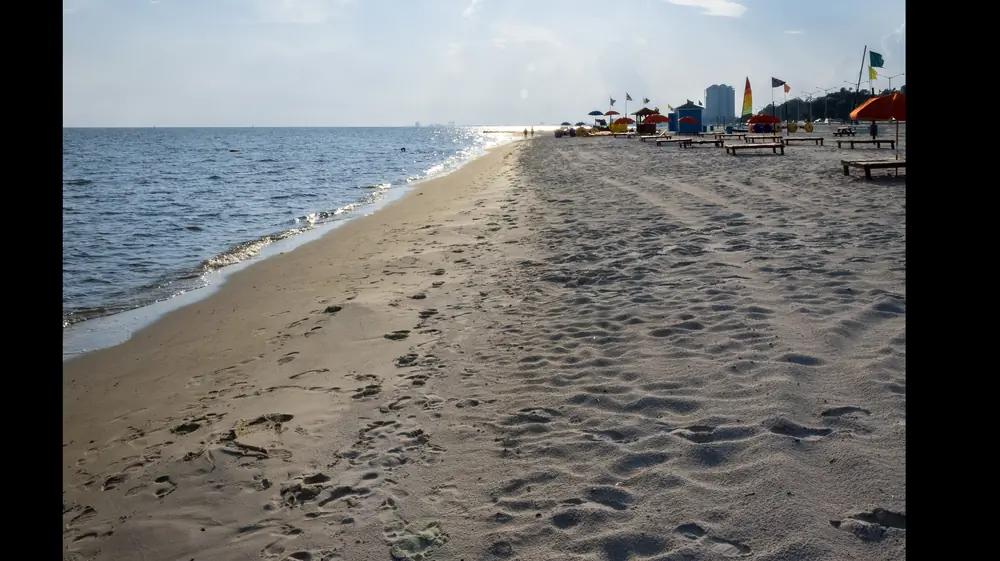 Sand beach curving along the Mississippi Sound on the Biloxi coastline at dusk
